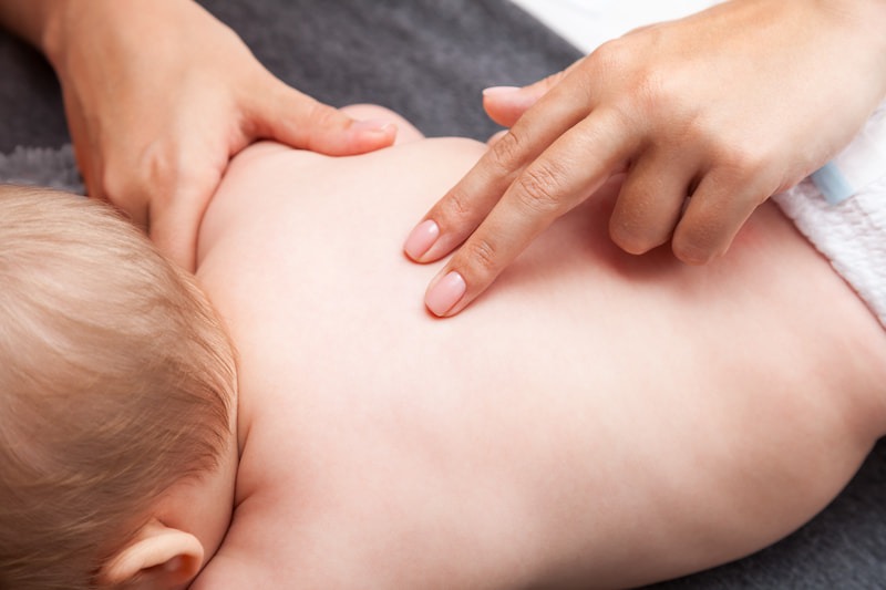 Baby hos osteopaten behandles for skævheder i ryggen